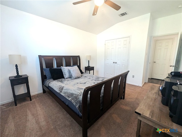 carpeted bedroom with a closet, vaulted ceiling, and ceiling fan