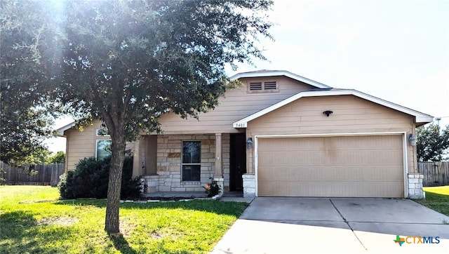 view of front of property featuring a garage and a front lawn