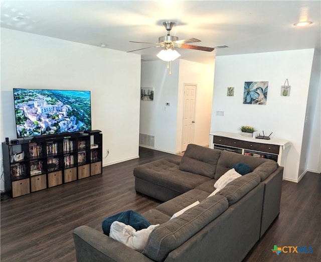 living room featuring dark wood-type flooring and ceiling fan