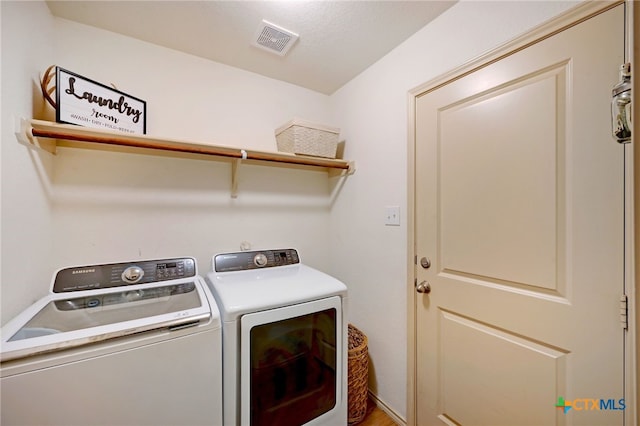 laundry room featuring washer and clothes dryer and a textured ceiling