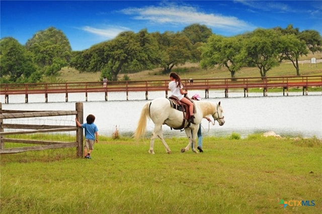 view of home's community with a rural view and a lawn