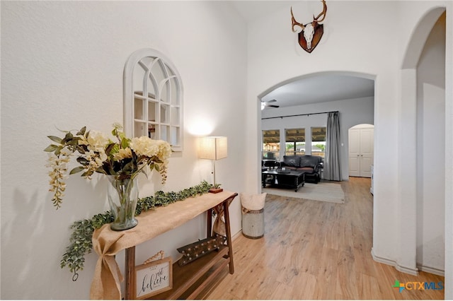 hallway with light hardwood / wood-style floors