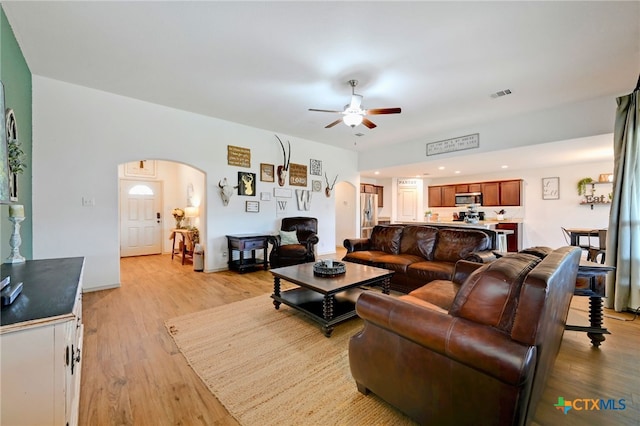 living room featuring ceiling fan and light hardwood / wood-style floors