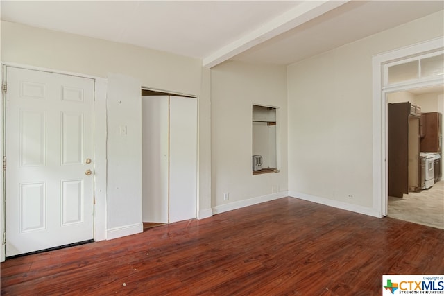 unfurnished bedroom featuring dark wood-type flooring