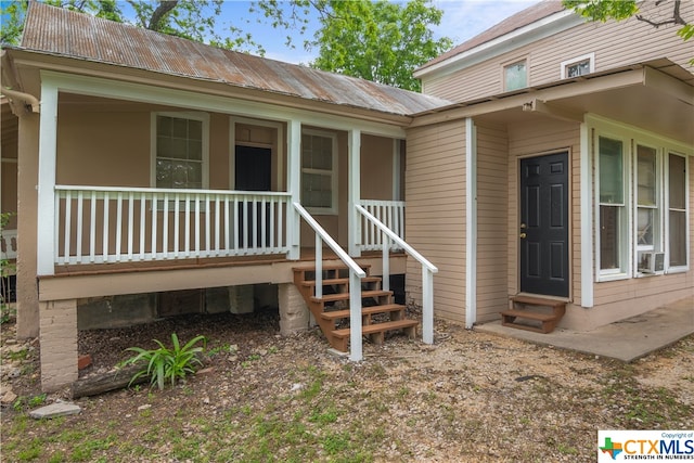 entrance to property featuring covered porch