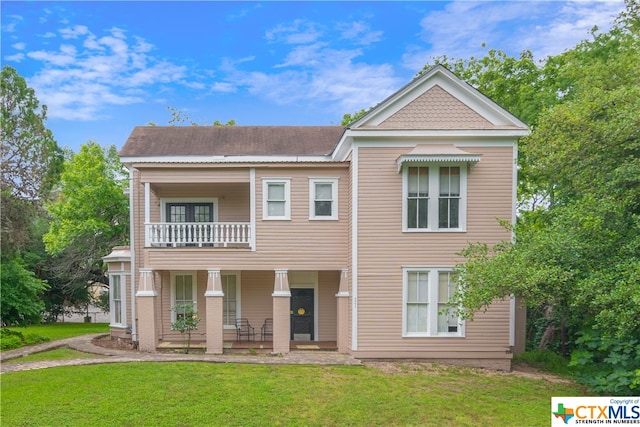 exterior space featuring a yard and a balcony