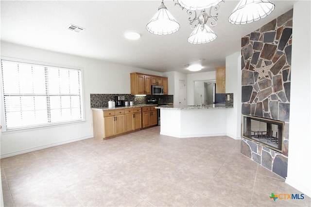 2216 Smith Bluff Rd, Salado, TX 76571 - kitchen with stainless steel appliances, a sink, tasteful backsplash, light stone countertops, and light tile patterned floors