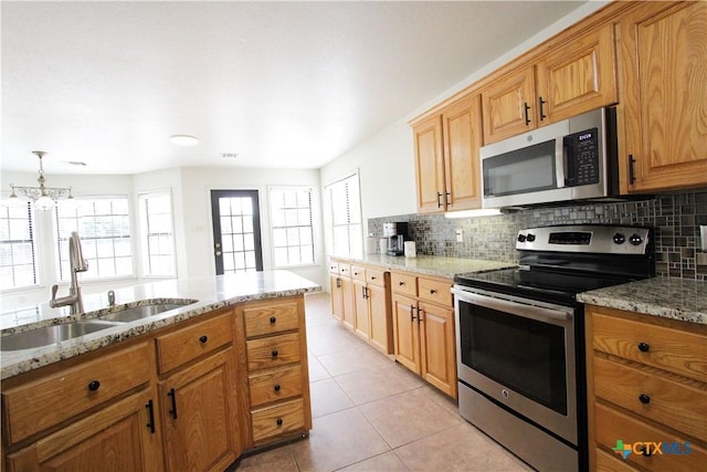 2216 Smith Bluff Rd, Salado, TX 76571 - kitchen featuring stainless steel appliances, a sink, tasteful backsplash, and light stone countertops