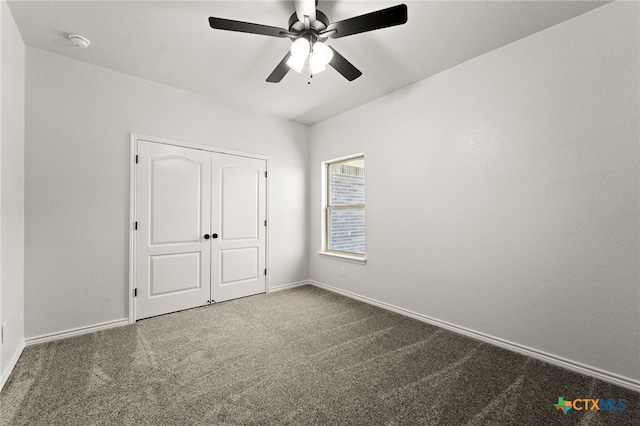 unfurnished bedroom with ceiling fan, a closet, and carpet floors