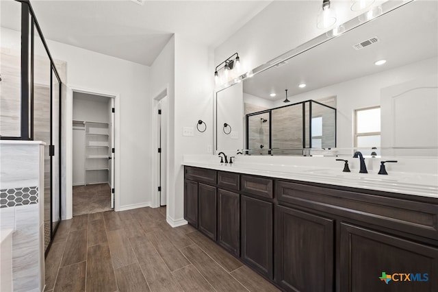 bathroom with an enclosed shower and vanity