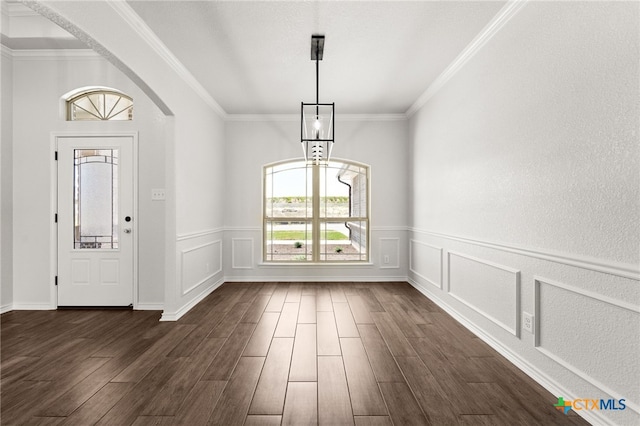 foyer featuring dark hardwood / wood-style floors and crown molding