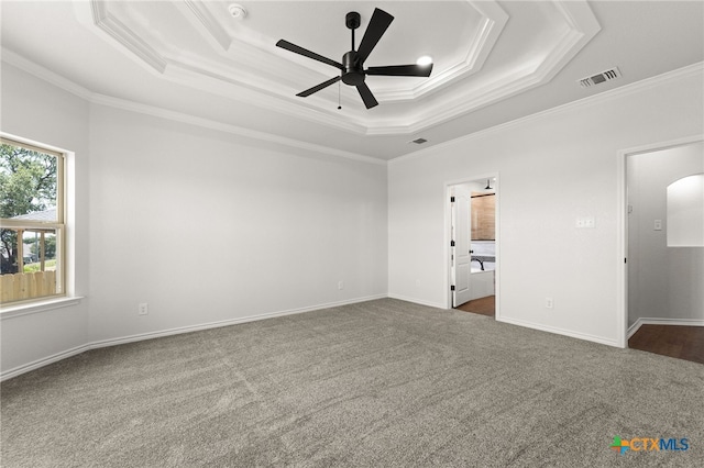 unfurnished bedroom with ornamental molding, ceiling fan, and a tray ceiling