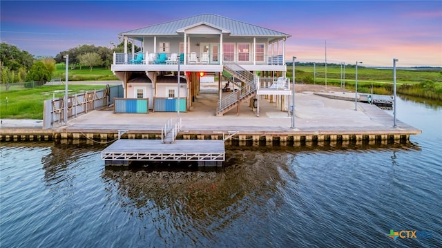 back house at dusk featuring a water view