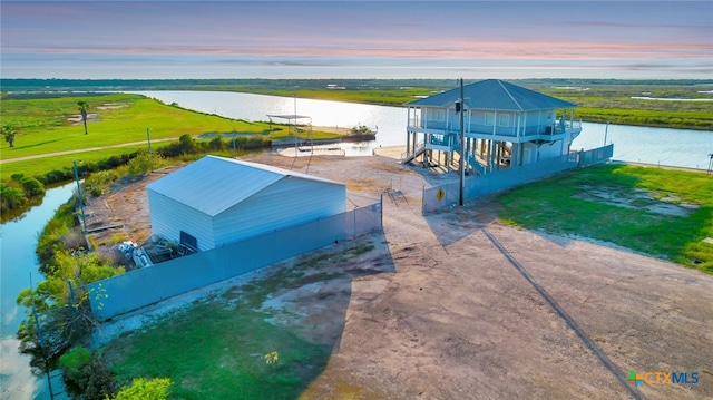 aerial view at dusk with a water view