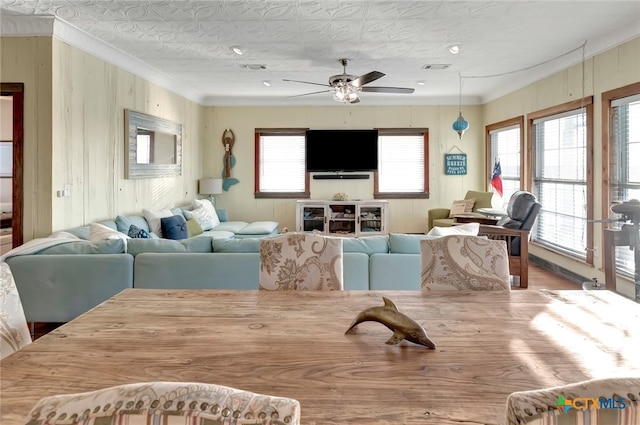 living room featuring ornamental molding and ceiling fan