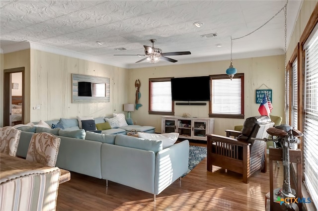 living room featuring wood-type flooring and ceiling fan