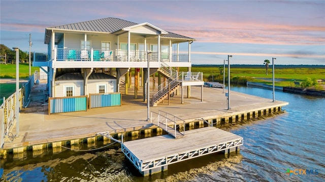 view of dock featuring a patio area and a water view