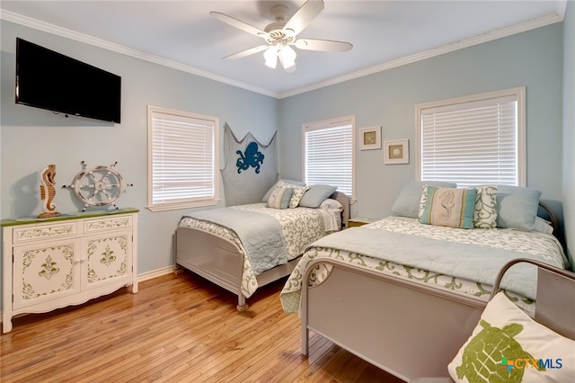 bedroom featuring light hardwood / wood-style flooring, ceiling fan, and crown molding