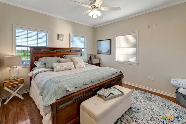 bedroom with hardwood / wood-style flooring, ceiling fan, and crown molding