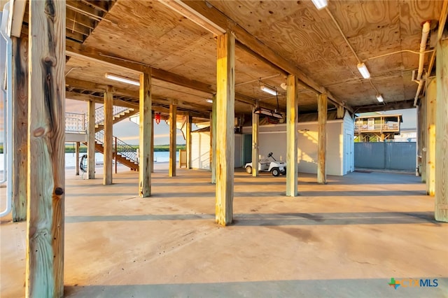 interior space featuring a water view and concrete floors