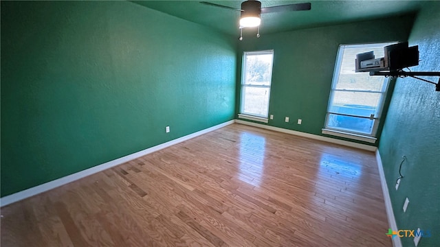 unfurnished room with hardwood / wood-style flooring and ceiling fan