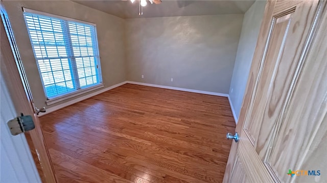 unfurnished room featuring ceiling fan and wood-type flooring