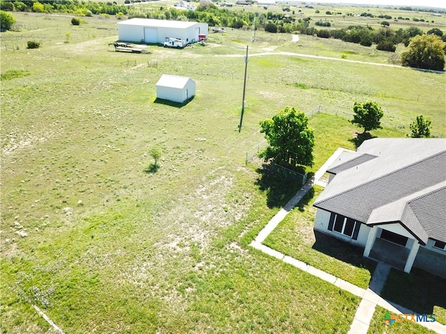 birds eye view of property with a rural view