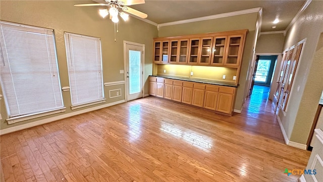 kitchen featuring ceiling fan, ornamental molding, and light hardwood / wood-style flooring