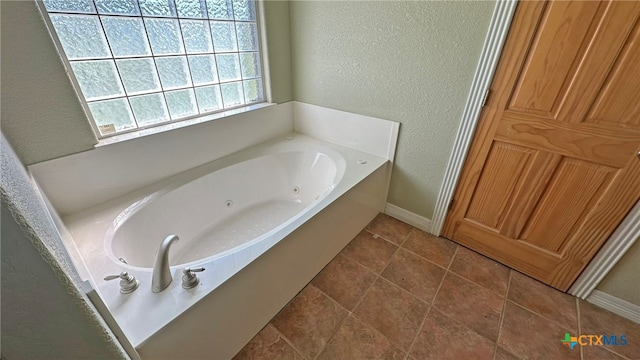 bathroom featuring a bath and tile patterned floors