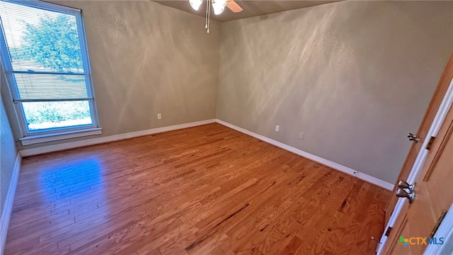 spare room featuring hardwood / wood-style floors and ceiling fan