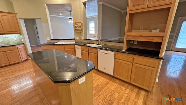 kitchen featuring crown molding, light wood-type flooring, sink, dishwasher, and kitchen peninsula