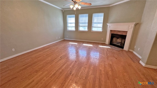 unfurnished living room featuring a fireplace, ceiling fan, light hardwood / wood-style flooring, and ornamental molding