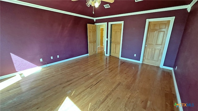 unfurnished bedroom featuring hardwood / wood-style flooring, ceiling fan, and ornamental molding