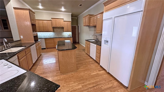 kitchen featuring light wood-type flooring, white appliances, sink, and a kitchen island