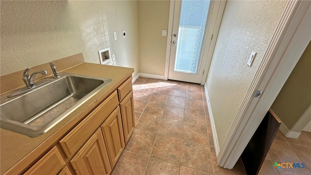 kitchen with light tile patterned floors and sink