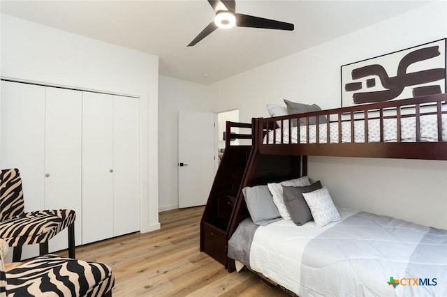 bedroom featuring ceiling fan, a closet, and light hardwood / wood-style floors