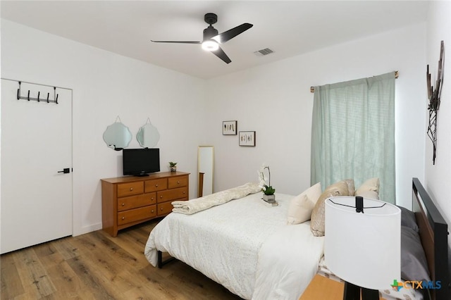 bedroom with ceiling fan and wood-type flooring