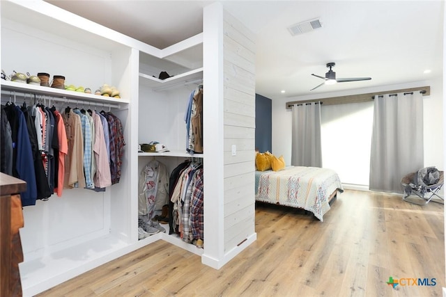 bedroom featuring ceiling fan, a closet, and wood-type flooring