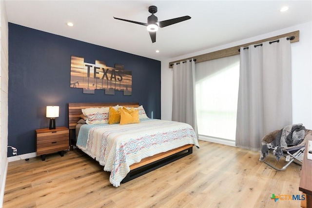 bedroom featuring hardwood / wood-style flooring and ceiling fan