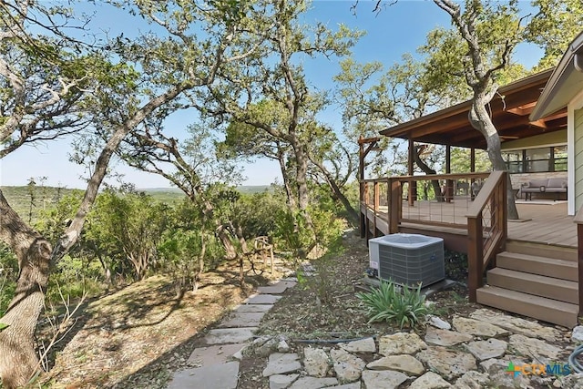 view of patio with central AC unit and a wooden deck