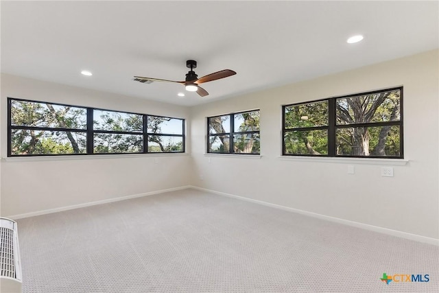 carpeted spare room with visible vents, baseboards, a ceiling fan, and recessed lighting