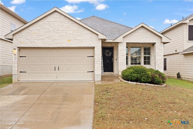 view of front facade with a garage and a front lawn