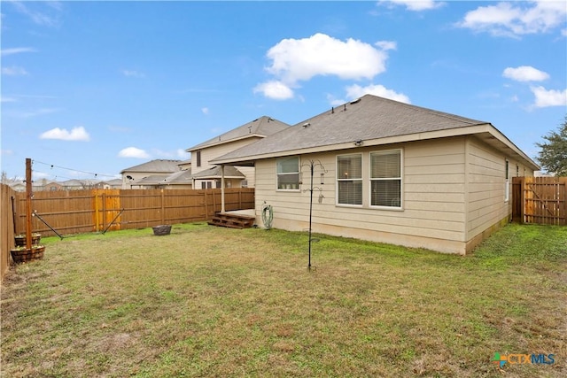 rear view of property featuring a yard