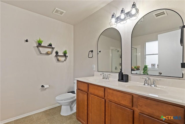 bathroom featuring vanity, tile patterned flooring, a shower with door, and toilet