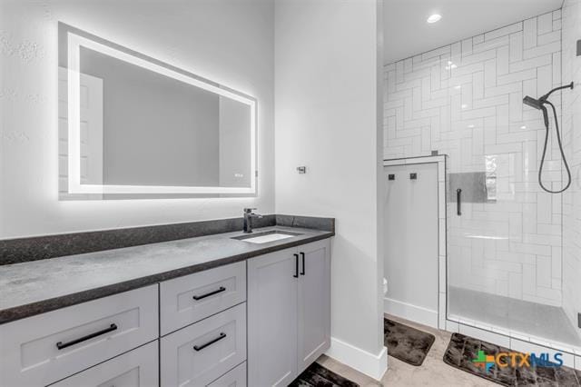 bathroom with vanity, a shower with shower door, and toilet