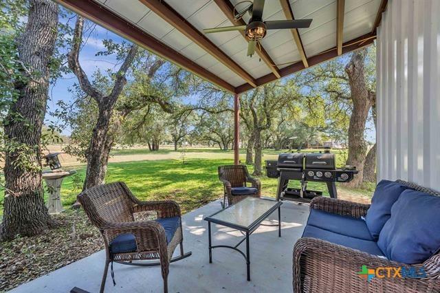 view of patio with outdoor lounge area, ceiling fan, and a grill