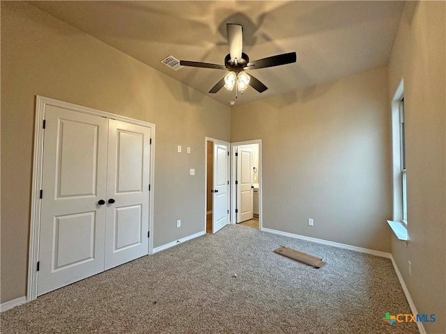 unfurnished bedroom with carpet, ceiling fan, and a closet