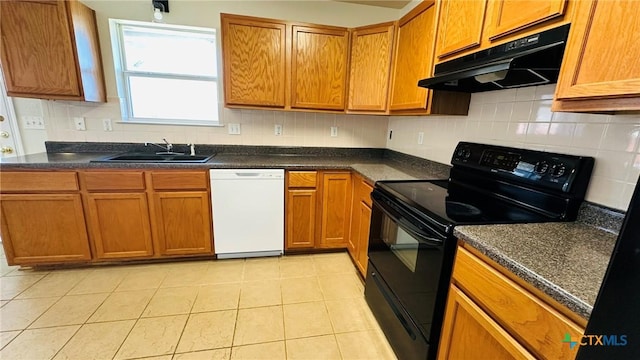 kitchen with dark countertops, black range with electric cooktop, white dishwasher, and under cabinet range hood