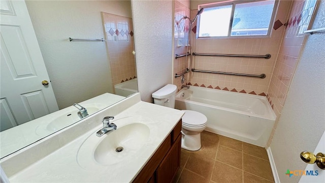 full bathroom with a textured wall, tile patterned flooring, toilet, vanity, and shower / bathing tub combination