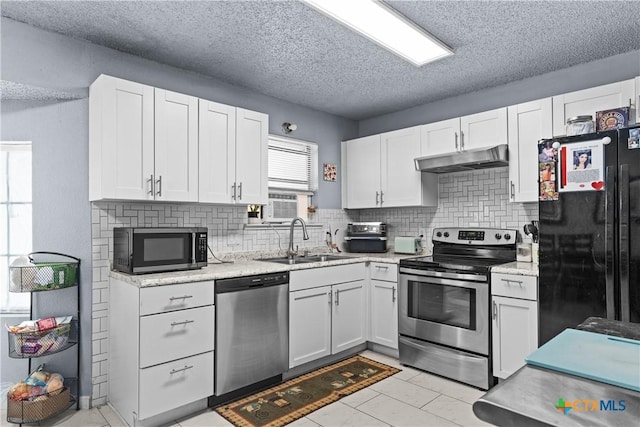 1003 Tyler Dr, Copperas Cove, TX 76522 - kitchen featuring appliances with stainless steel finishes, under cabinet range hood, backsplash, white cabinets, and a textured ceiling